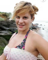 Nora is in the bikini and nude on the beach