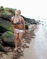 Nora is in the bikini and nude on the beach