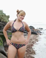 Nora is in the bikini and nude on the beach