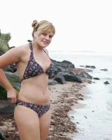 Nora is in the bikini and nude on the beach