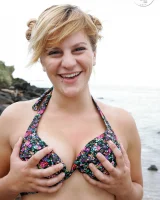 Nora is in the bikini and nude on the beach