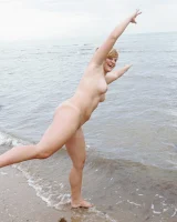 Nora is in the bikini and nude on the beach