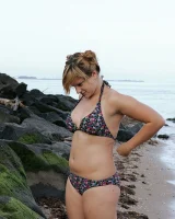 Nora is in the bikini and nude on the beach