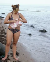 Nora is in the bikini and nude on the beach