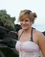 Nora is in the bikini and nude on the beach