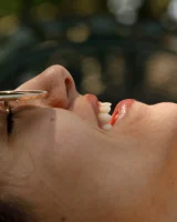 Busty latin baby Adriene Macedo is in the pool in sexy dark red bikini