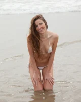 Sexy baby Coco Rose is on the beach in white micro bikini