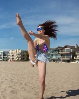 Tits flashing playful busty Elizabeth Marxs has fun on the beach in motley bikini