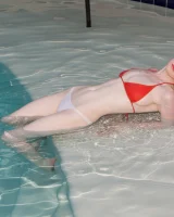 Redhead beauty Emily Archer visiting pool in sexy red and white bikini
