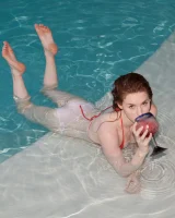Redhead beauty Emily Archer visiting pool in sexy red and white bikini