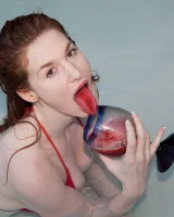 Redhead beauty Emily Archer visiting pool in sexy red and white bikini