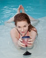 Redhead beauty Emily Archer visiting pool in sexy red and white bikini