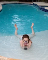 Redhead beauty Emily Archer visiting pool in sexy red and white bikini