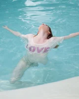 Redhead beauty Emily Archer visiting pool in sexy red and white bikini