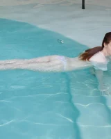 Redhead beauty Emily Archer visiting pool in sexy red and white bikini