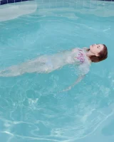 Redhead beauty Emily Archer visiting pool in sexy red and white bikini