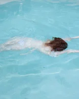 Redhead beauty Emily Archer visiting pool in sexy red and white bikini