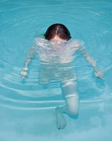 Redhead beauty Emily Archer visiting pool in sexy red and white bikini