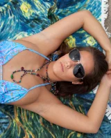 Beach volleyball player Eva Lovia in sexy orange and blue bikini