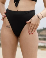 Busty chick Jade Baker is sexy skateboarder in cut tiny jeans shorts and fantastic baby in black bikini on the beach