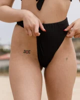 Busty chick Jade Baker is sexy skateboarder in cut tiny jeans shorts and fantastic baby in black bikini on the beach