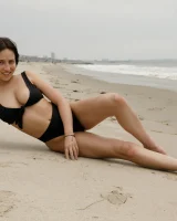 Busty chick Jade Baker is sexy skateboarder in cut tiny jeans shorts and fantastic baby in black bikini on the beach