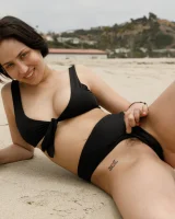 Busty chick Jade Baker is sexy skateboarder in cut tiny jeans shorts and fantastic baby in black bikini on the beach