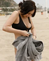 Busty chick Jade Baker is sexy skateboarder in cut tiny jeans shorts and fantastic baby in black bikini on the beach