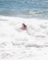 Sweet brunette Natalie Moore is sexy in the sea and on the beach wearing blue and pink bikini