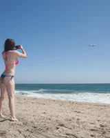 Sweet brunette Natalie Moore is sexy in the sea and on the beach wearing blue and pink bikini