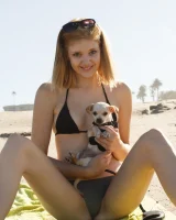 Amateur babe Sloan Kendricks enjoys a day on the beach modeling her swimsuits