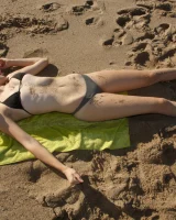 Amateur babe Sloan Kendricks enjoys a day on the beach modeling her swimsuits