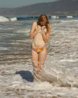 Amateur babe Sloan Kendricks enjoys a day on the beach modeling her swimsuits