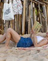 Young sexy goddess Sonia Clarice is in pink bikini with cameltoe and nude showing puffy nipples on the trashy beach