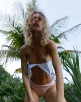 Young sexy goddess Sonia Clarice is in pink bikini with cameltoe and nude showing puffy nipples on the trashy beach