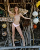 Young sexy goddess Sonia Clarice is in pink bikini with cameltoe and nude showing puffy nipples on the trashy beach