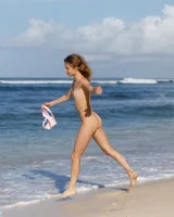 Young sexy goddess Sonia Clarice is in pink bikini with cameltoe and nude showing puffy nipples on the trashy beach