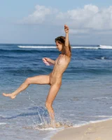 Young sexy goddess Sonia Clarice is in pink bikini with cameltoe and nude showing puffy nipples on the trashy beach