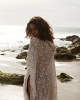 Brunette American Sonya Ash strips her bikini top on the beach and poses