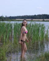 Exciting young chick in bikini is nude in the lake