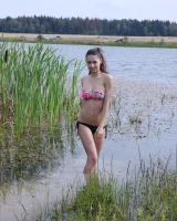 Exciting young chick in bikini is nude in the lake