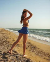 Hairy pussy baby in bikini is nude on the beach