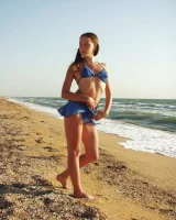 Hairy pussy baby in bikini is nude on the beach