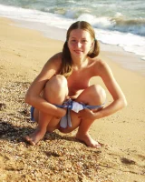 Hairy pussy baby in bikini is nude on the beach