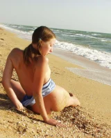 Hairy pussy baby in bikini is nude on the beach