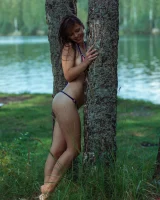 Perfect body young brunette in sexy micro bikini swimming nude