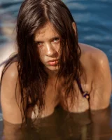 Perfect body young brunette in sexy micro bikini swimming nude