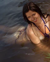 Perfect body young brunette in sexy micro bikini swimming nude