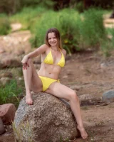 Stripping yellow bikini at the sea