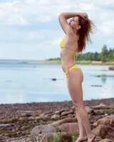 Stripping yellow bikini at the sea